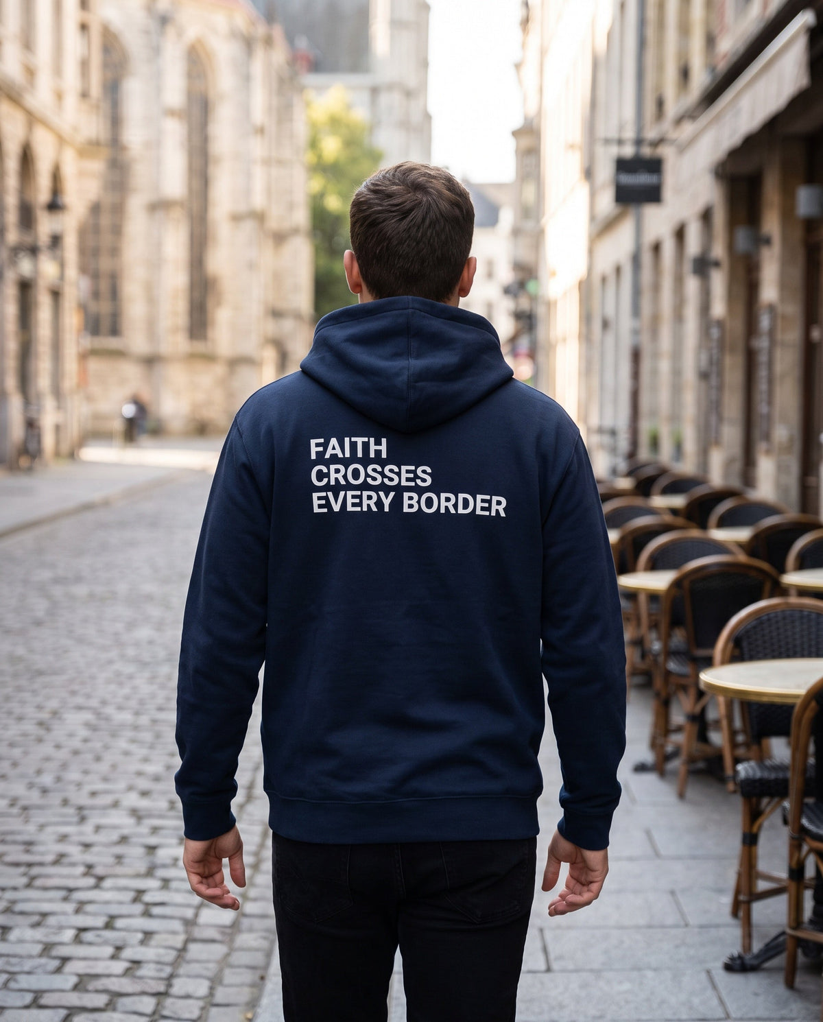 Back of a navy Faith Crosses Every Border Christian hoodie showing the large back print