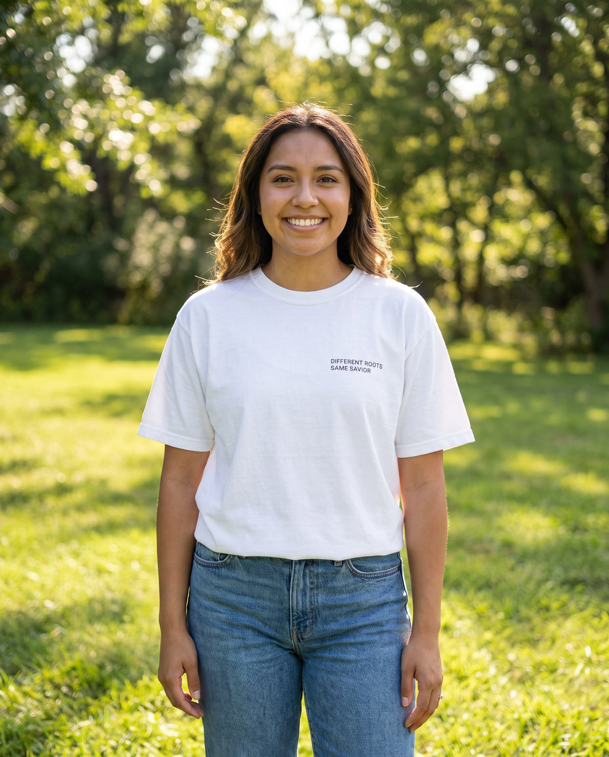Woman wearing a white Different Roots. Same Savior Christian t-shirt, chest print
