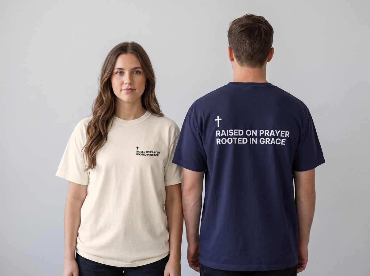 Couple wearing Raised on Prayer. Rooted in Grace Cross Edition Christian t-shirts, front chest print and large back print