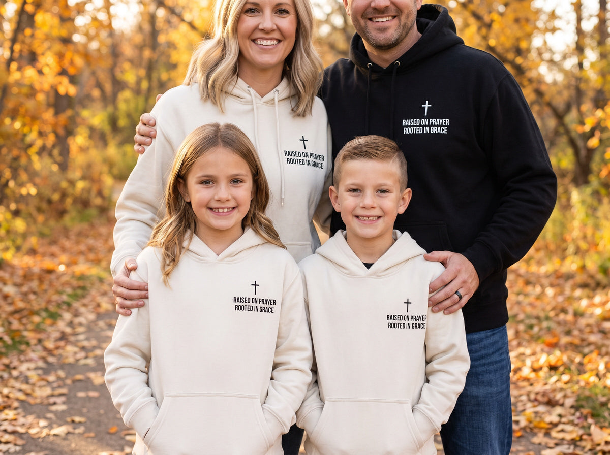 Family wearing matching Raised on Prayer. Rooted in Grace Cross Edition Christian hoodies