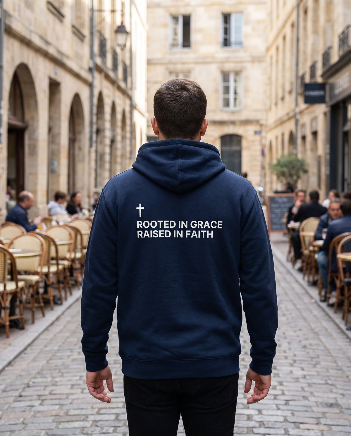 Back of a navy Rooted in Grace. Raised in Faith Cross Edition Christian hoodie showing the large back print