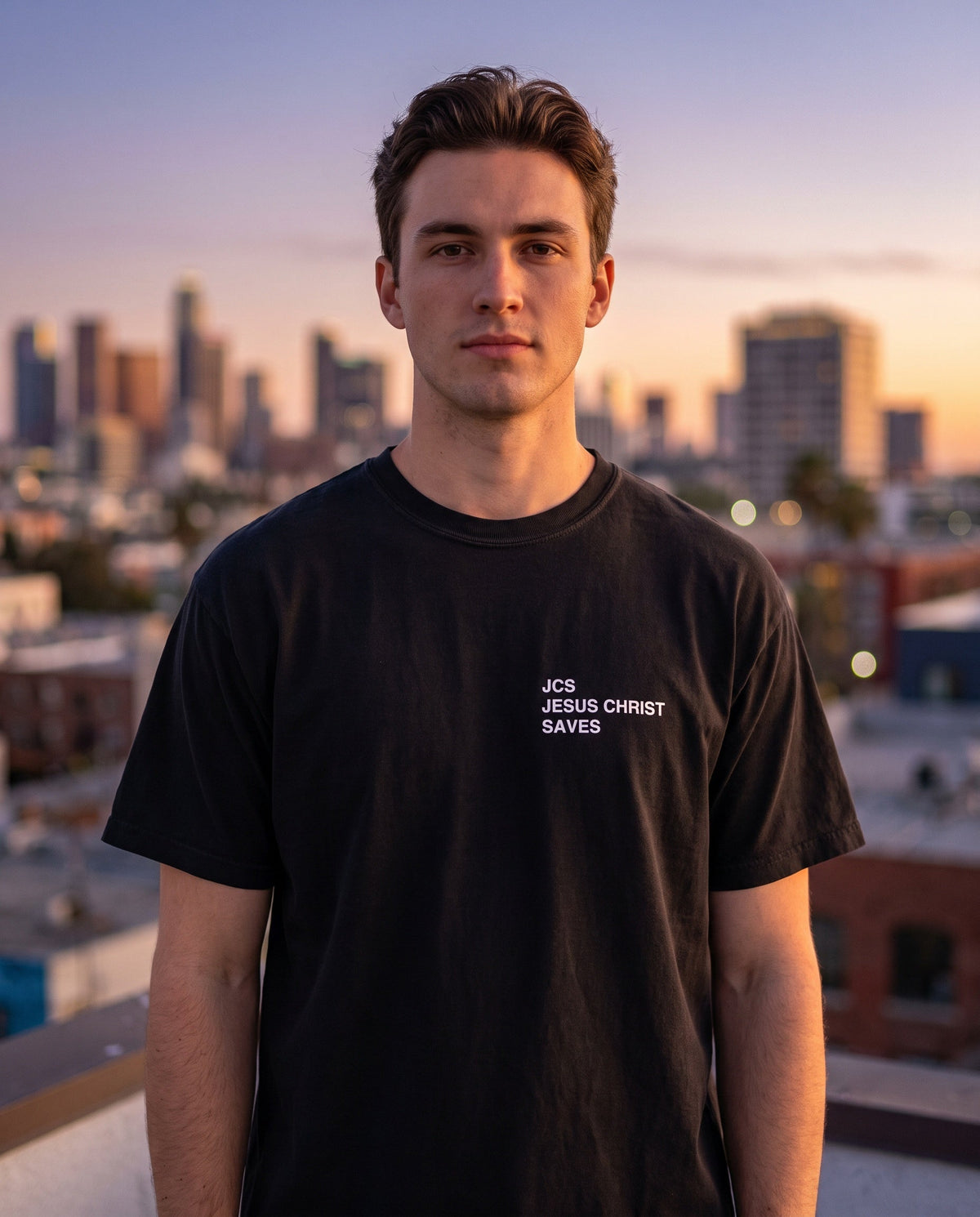 Man wearing a black JCS — Jesus Christ Saves Christian t-shirt, chest print