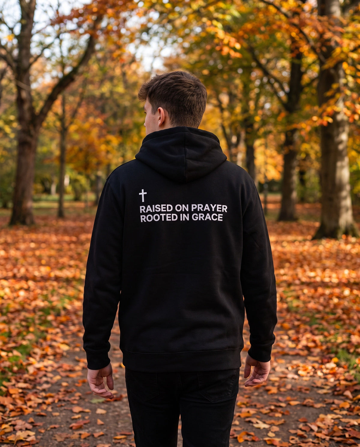 Back of a black Raised on Prayer. Rooted in Grace Cross Edition Christian hoodie showing the large back print