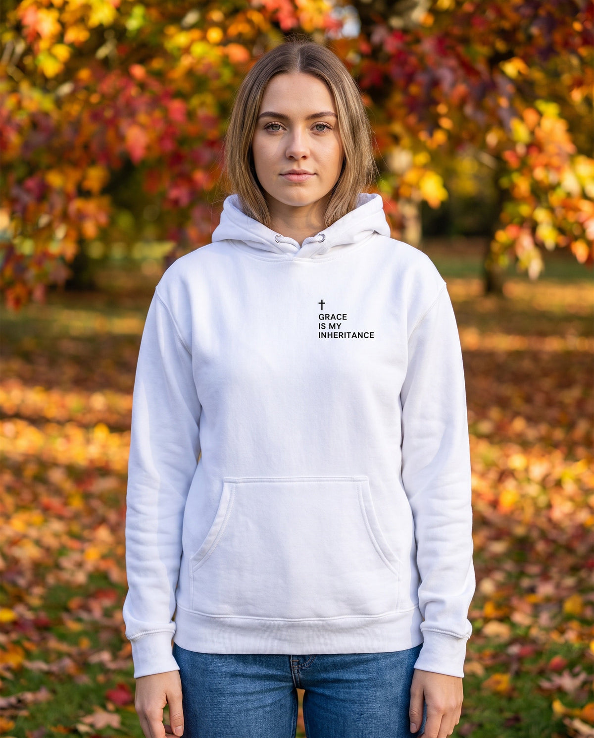 Woman wearing a white Grace Is My Inheritance Cross Edition Christian hoodie with cross chest print