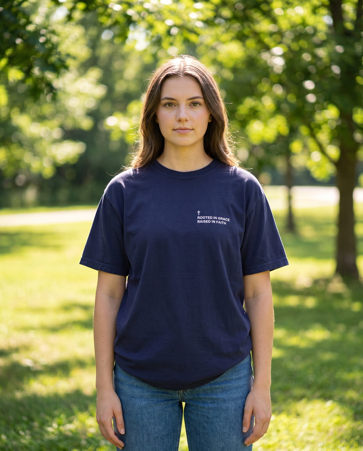 Woman wearing a truenavy Rooted in Grace. Raised in Faith Cross Edition Christian t-shirt with cross chest print