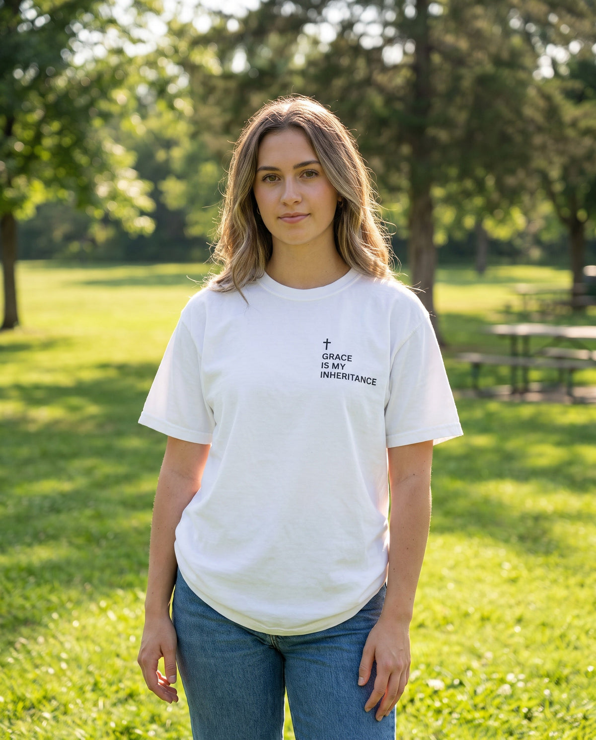 Woman wearing a white Grace Is My Inheritance Cross Edition Christian t-shirt, cross chest print