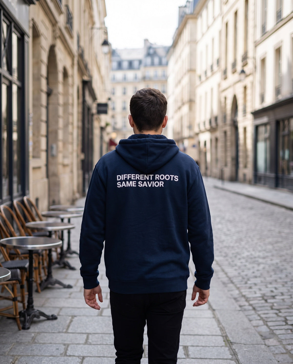 Back of a navy Different Roots. Same Savior Christian hoodie showing the large back print