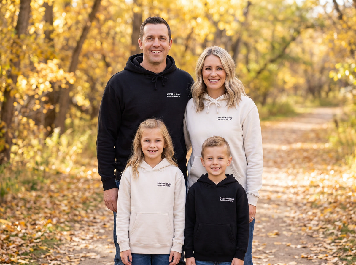 Family wearing matching Rooted in Grace. Raised in Faith Christian hoodies