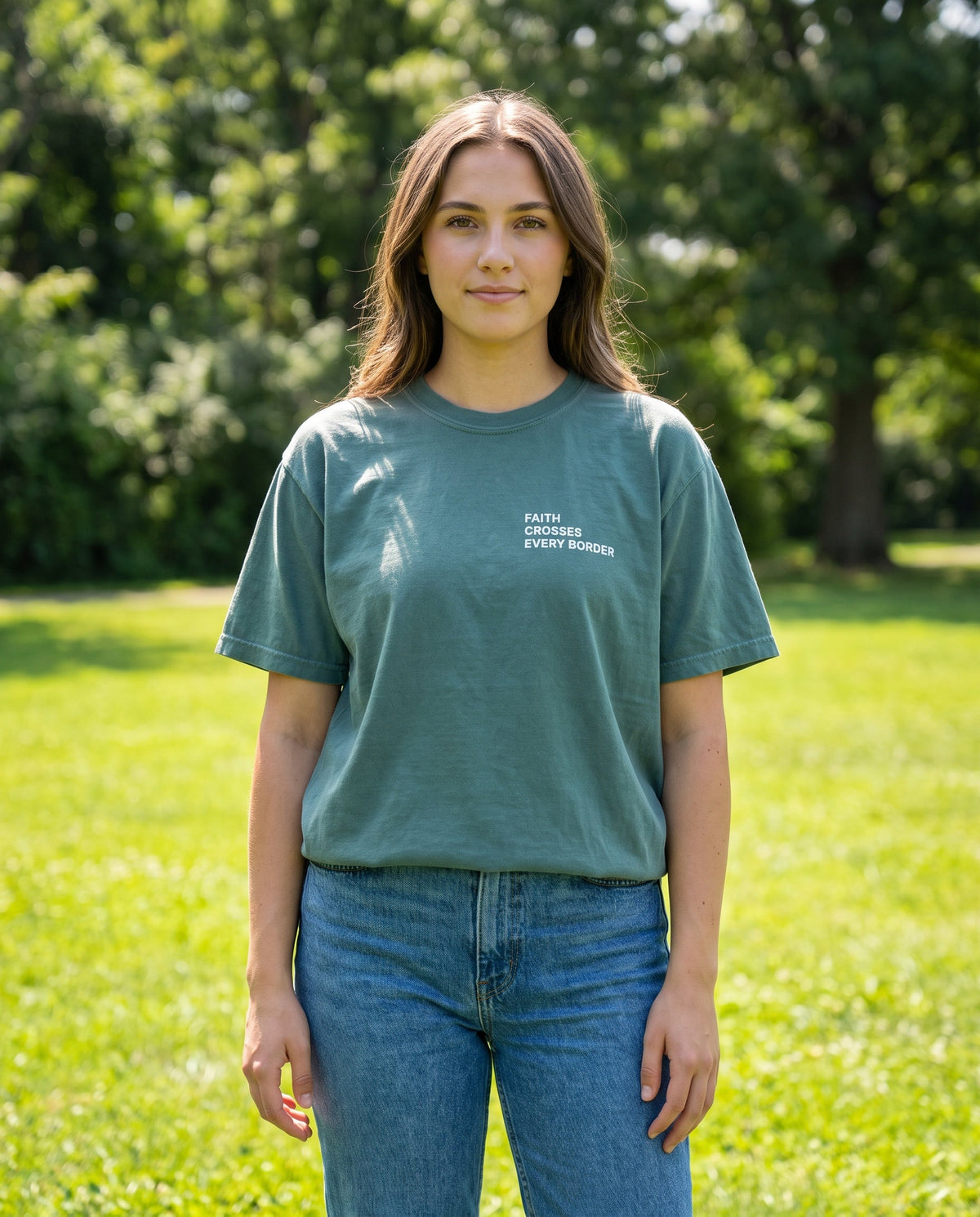 Woman wearing a bluespruce Faith Crosses Every Border Christian t-shirt, chest print