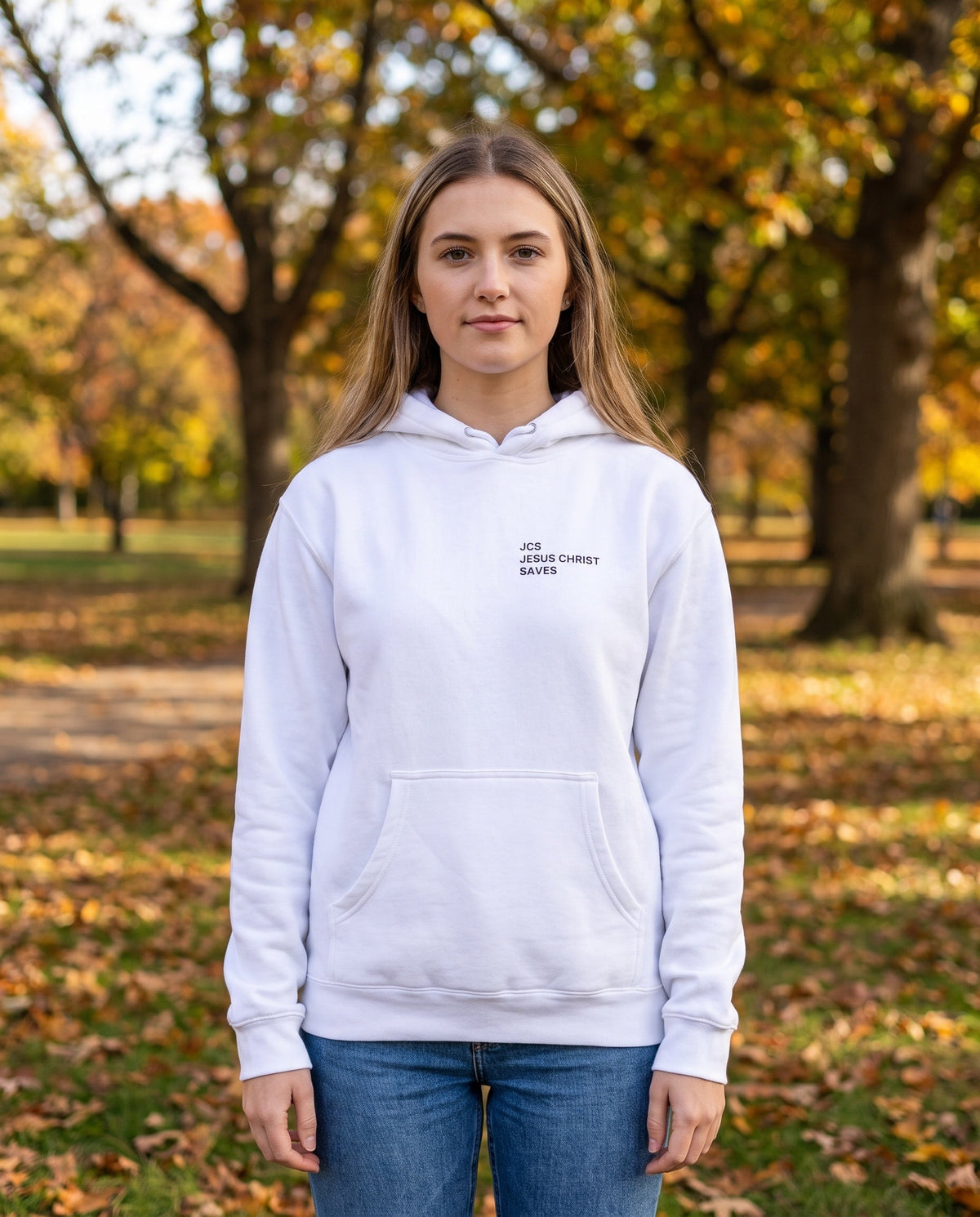 Woman wearing a white JCS — Jesus Christ Saves Christian hoodie, chest print