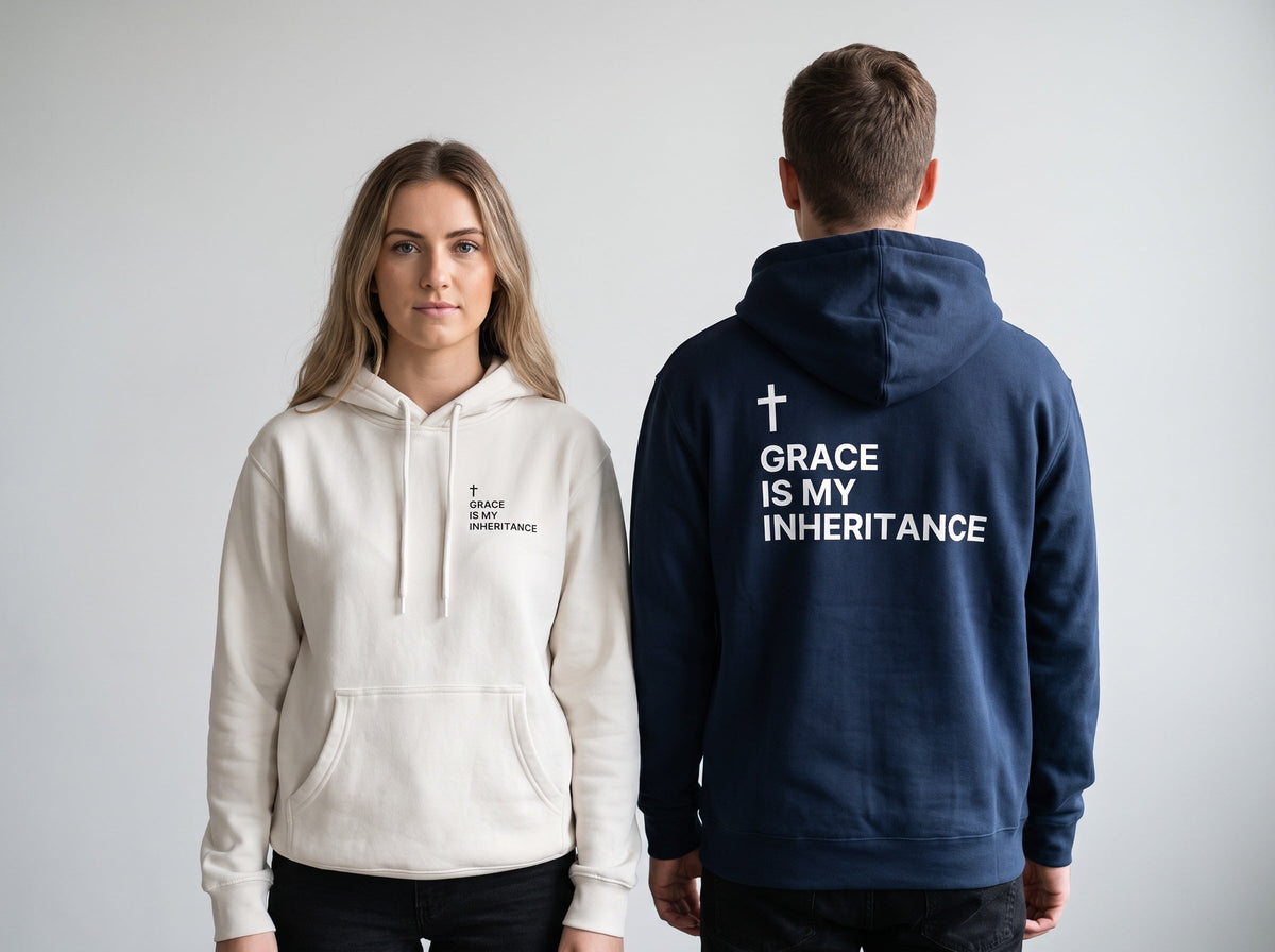 Couple wearing Grace Is My Inheritance Cross Edition Christian hoodies, bone front and navy back print