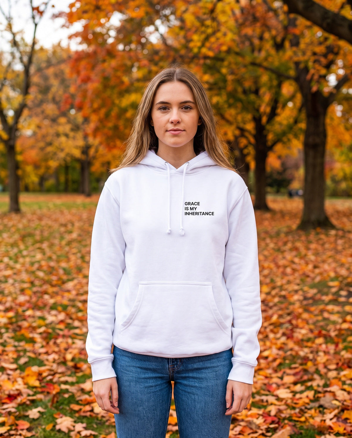Woman wearing a white Grace Is My Inheritance Christian hoodie, chest print