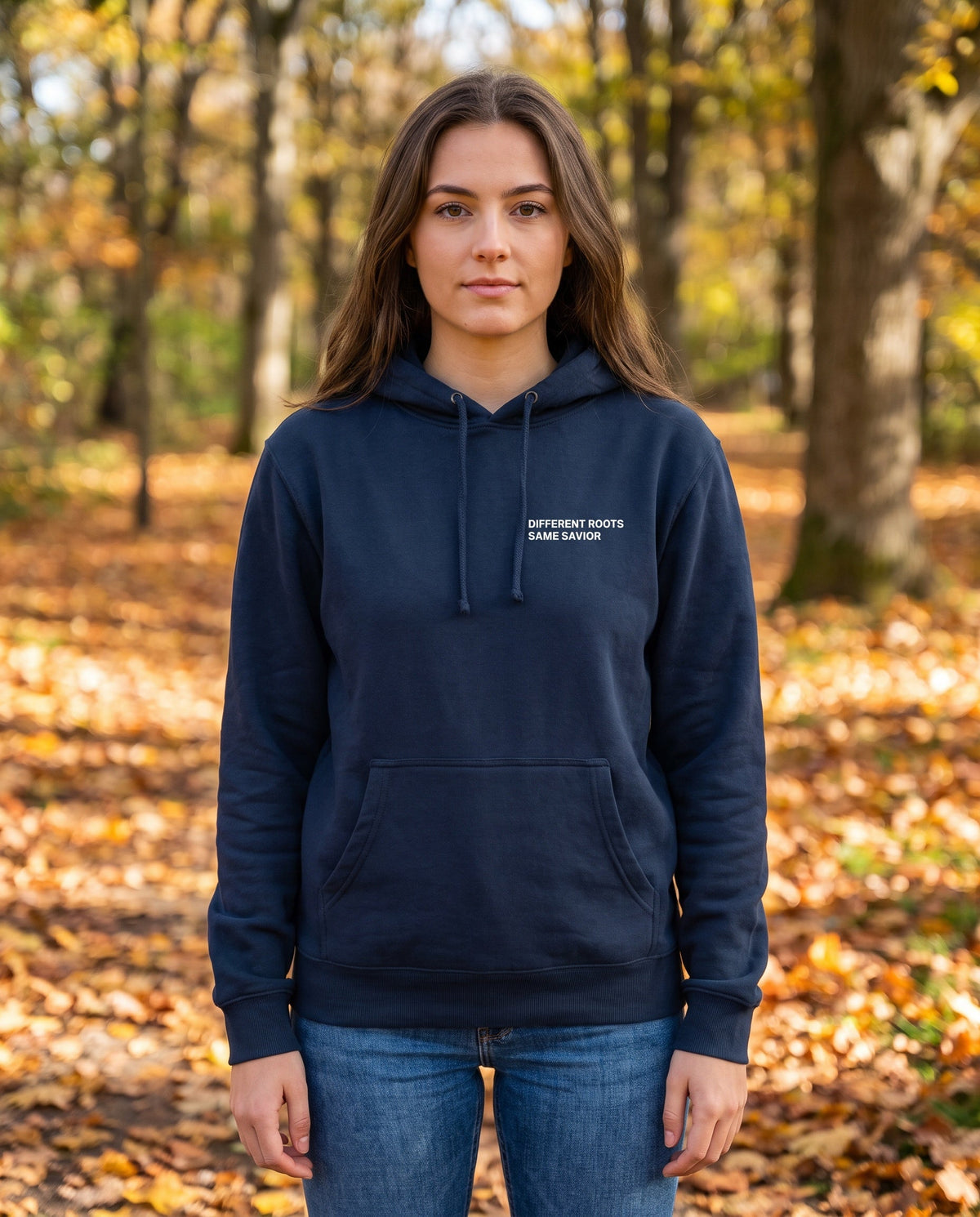 Woman wearing a navy Different Roots. Same Savior Christian hoodie, chest print