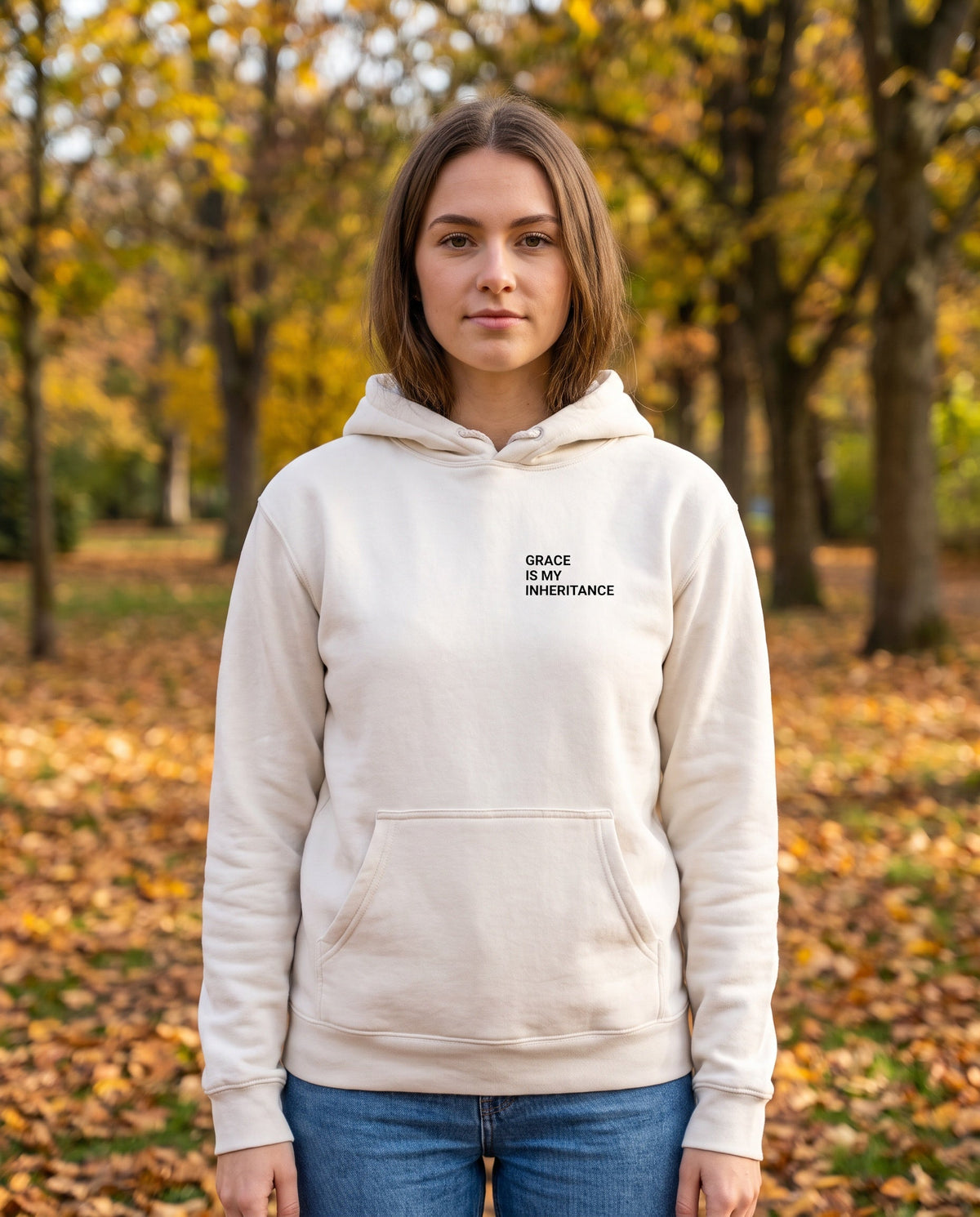 Woman wearing a bone off-white Grace Is My Inheritance Christian hoodie, chest print
