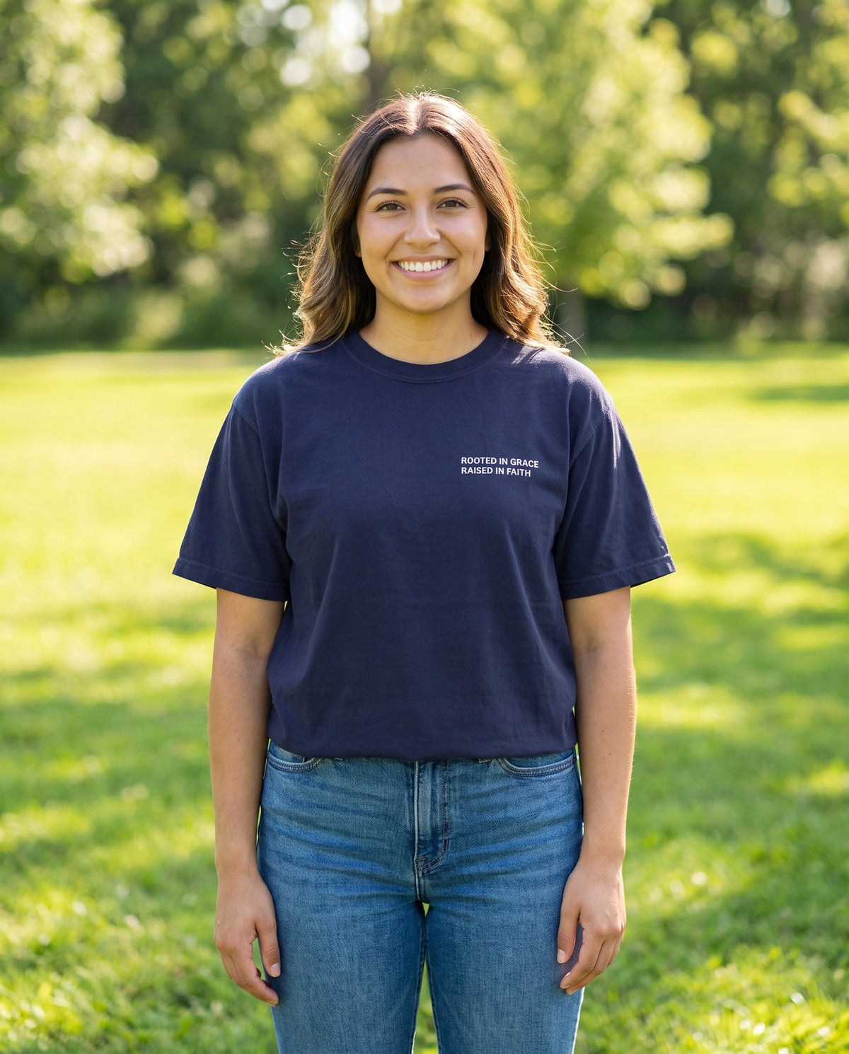 Woman wearing a truenavy Rooted in Grace. Raised in Faith Christian t-shirt, chest print
