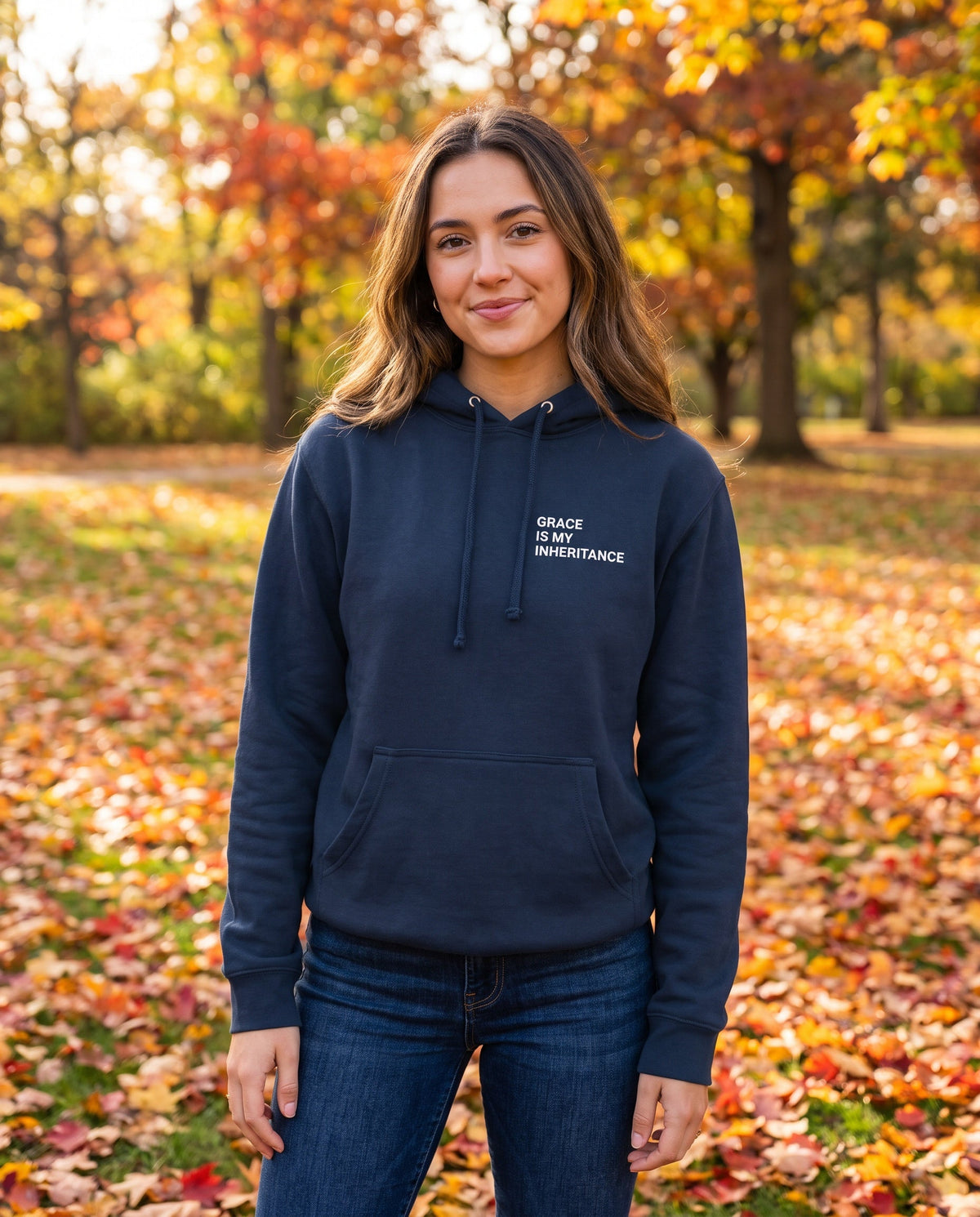 Woman wearing a navy Grace Is My Inheritance Christian hoodie, chest print