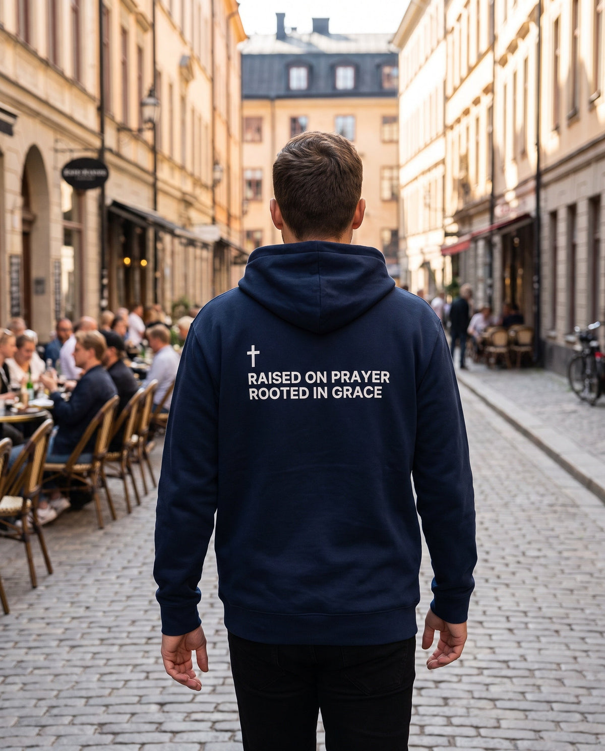 Back of a navy Raised on Prayer. Rooted in Grace Cross Edition Christian hoodie showing the large back print