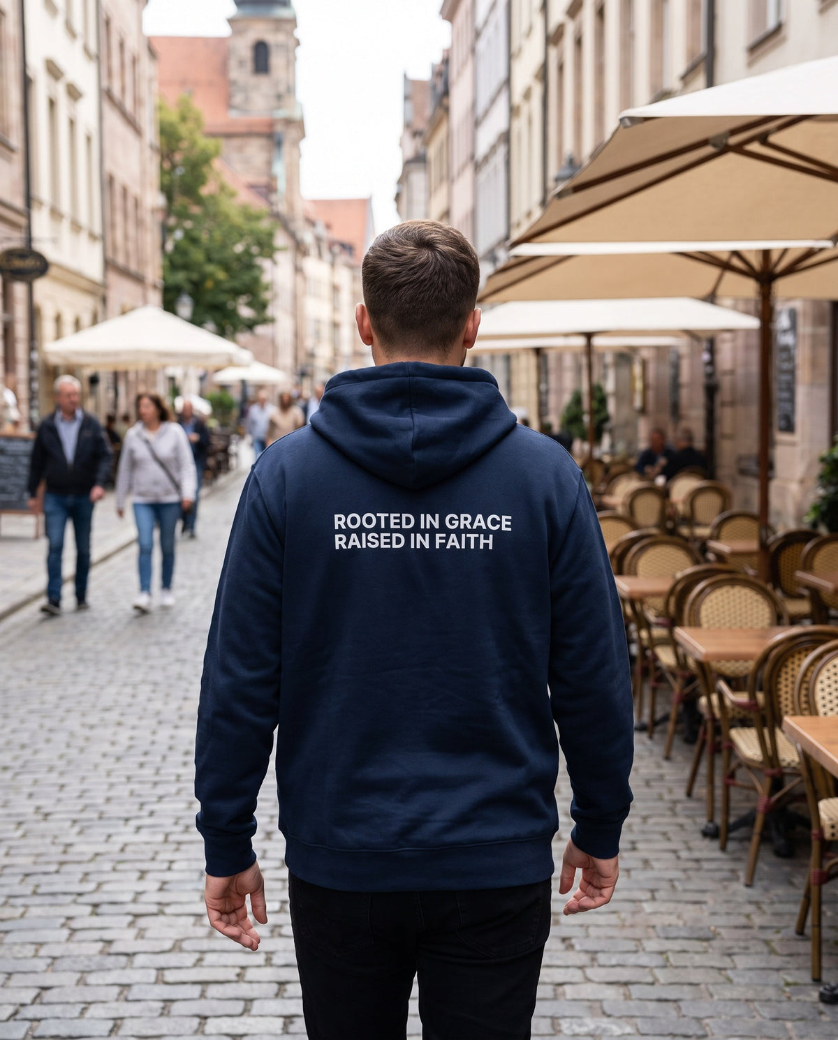 Back of a navy Rooted in Grace. Raised in Faith Christian hoodie showing the large back print