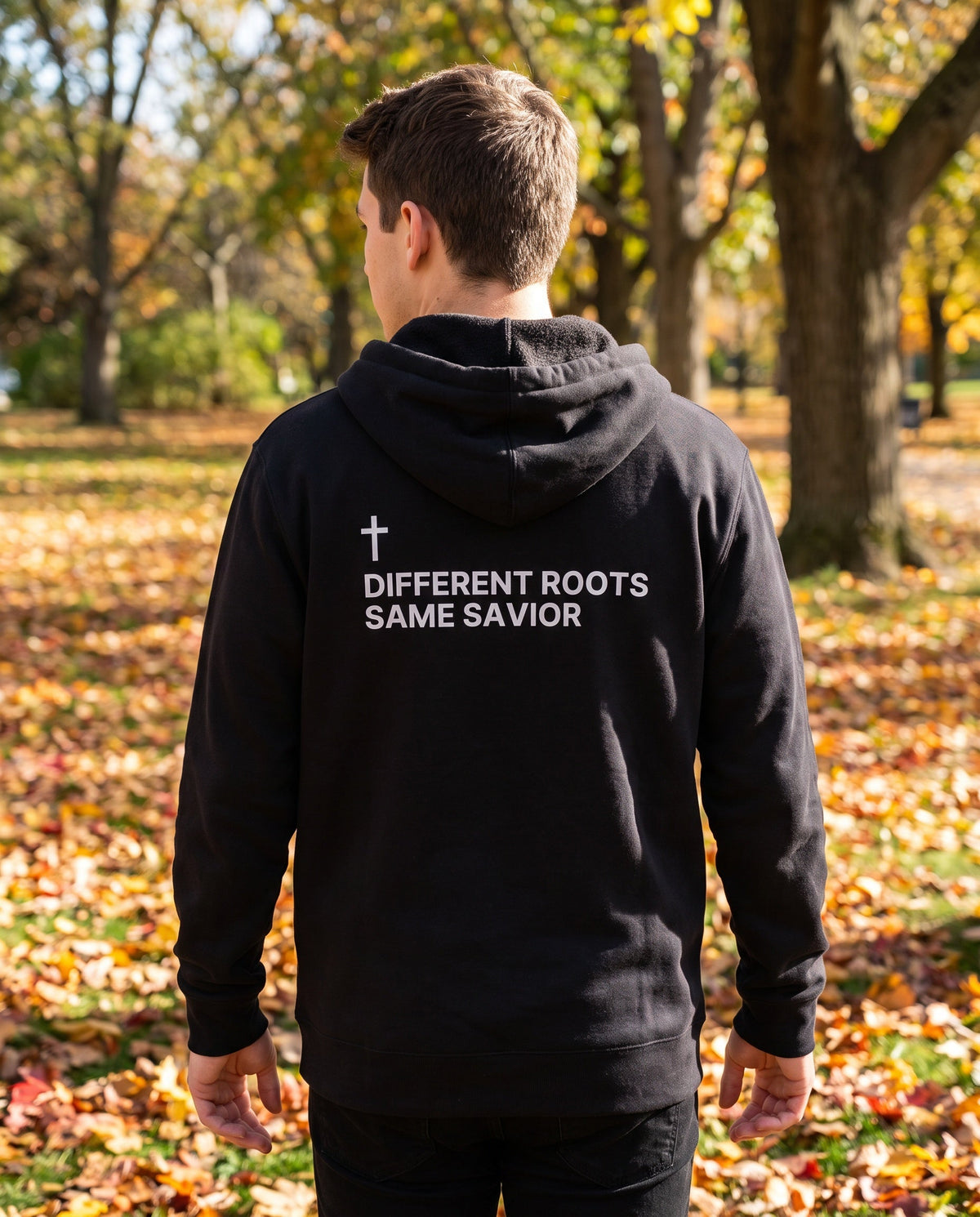 Back of a black Different Roots. Same Savior Cross Edition Christian hoodie showing the large back print