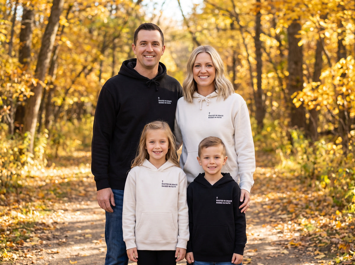 Family wearing matching Rooted in Grace. Raised in Faith Cross Edition Christian hoodies