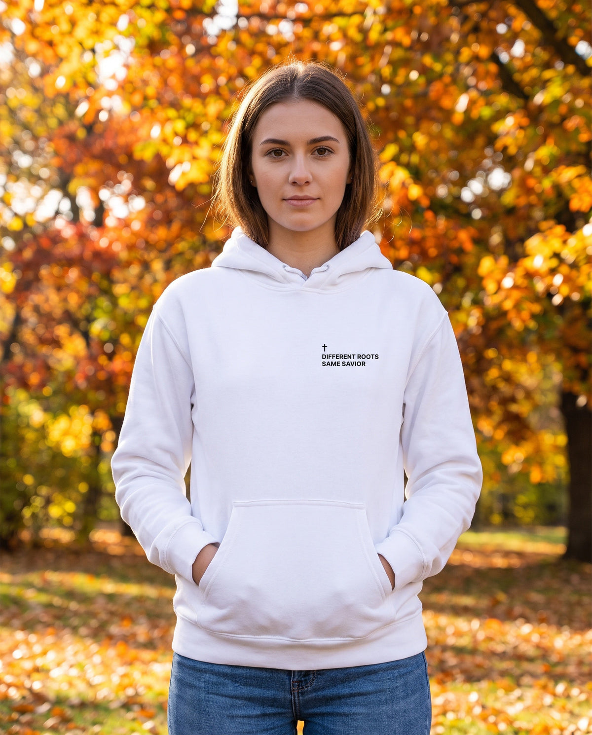 Woman wearing a white Different Roots. Same Savior Cross Edition Christian hoodie with cross chest print