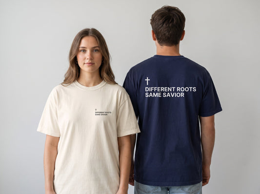 Couple wearing Different Roots. Same Savior Cross Edition Christian t-shirts, front chest print and large back print