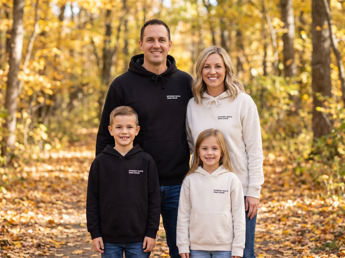 Family wearing matching Different Roots. Same Savior Christian hoodies