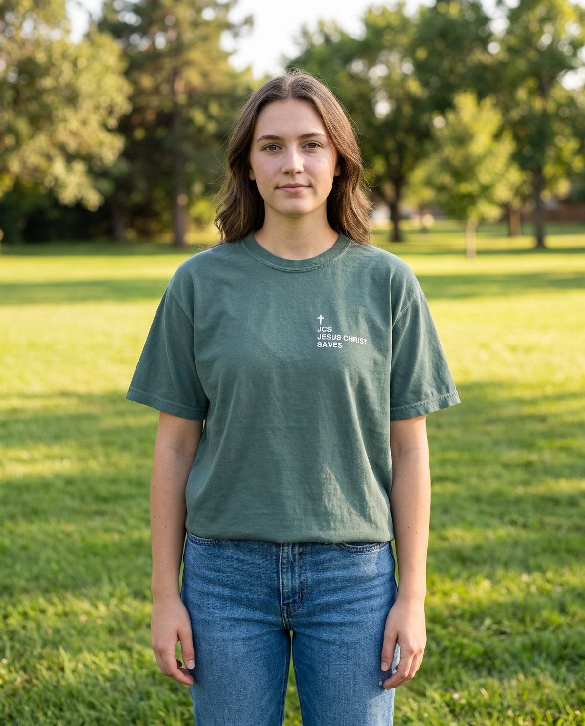 Woman wearing a bluespruce JCS — Jesus Christ Saves Cross Edition Christian t-shirt with cross chest print