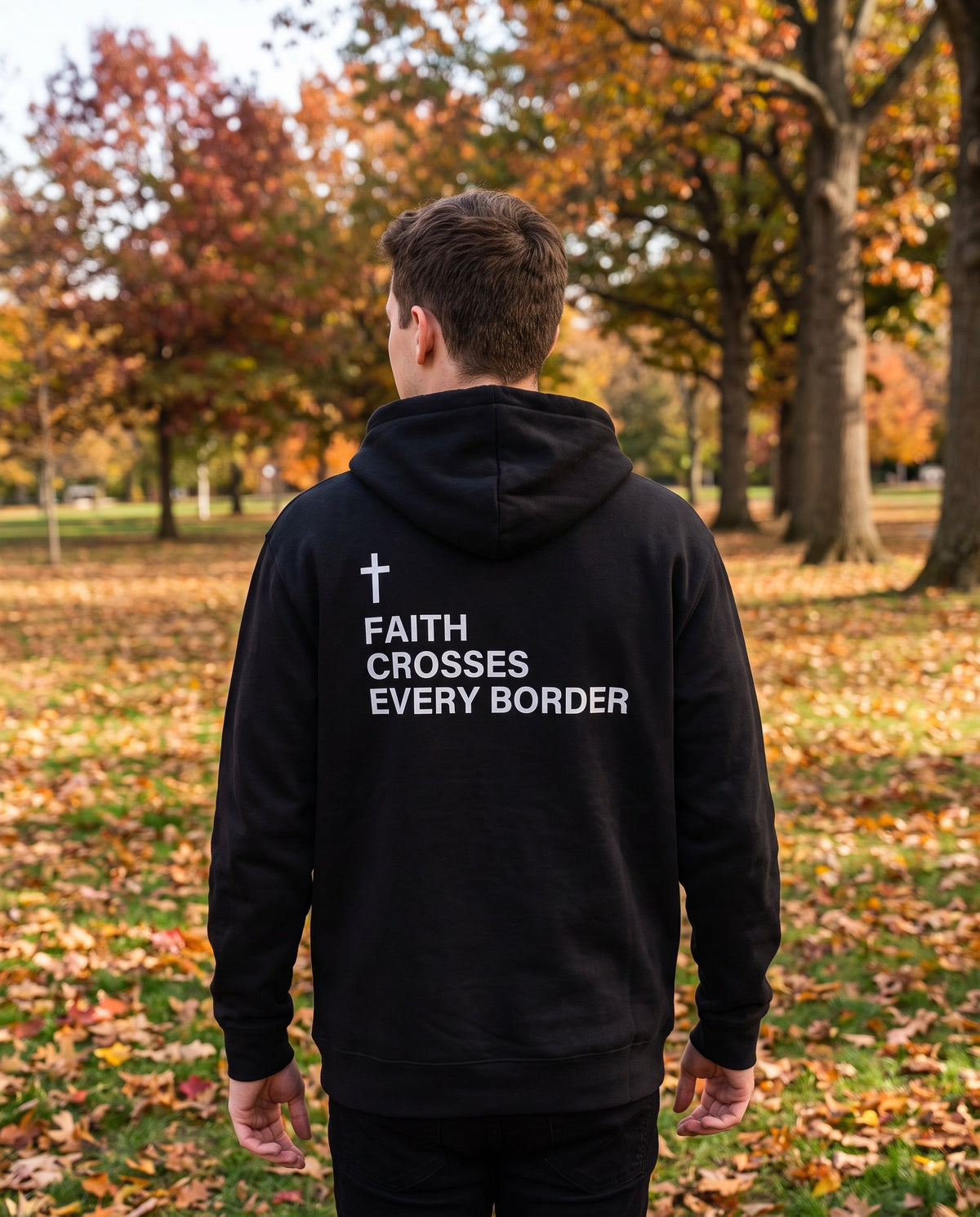 Back of a black Faith Crosses Every Border Cross Edition Christian hoodie showing the large back print