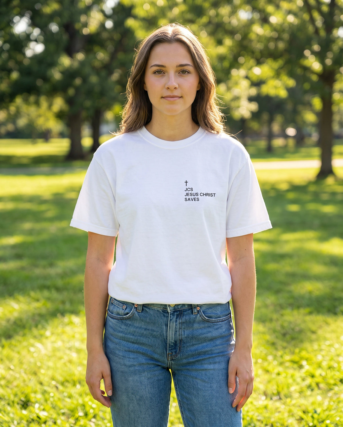 Woman wearing a white JCS — Jesus Christ Saves Cross Edition Christian t-shirt with cross chest print