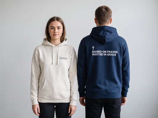 Couple wearing Raised on Prayer. Rooted in Grace Cross Edition Christian hoodies, front chest print and large back print