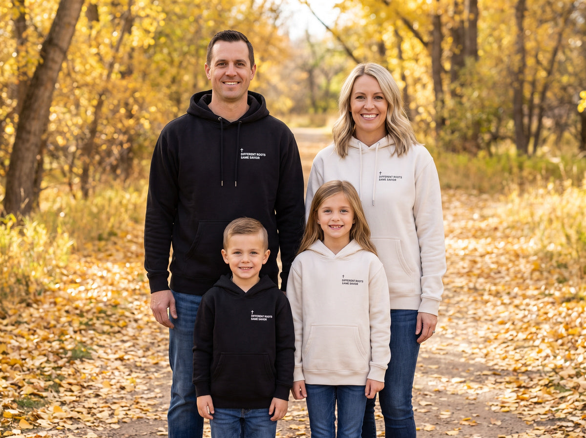 Family wearing matching Different Roots. Same Savior Cross Edition Christian hoodies