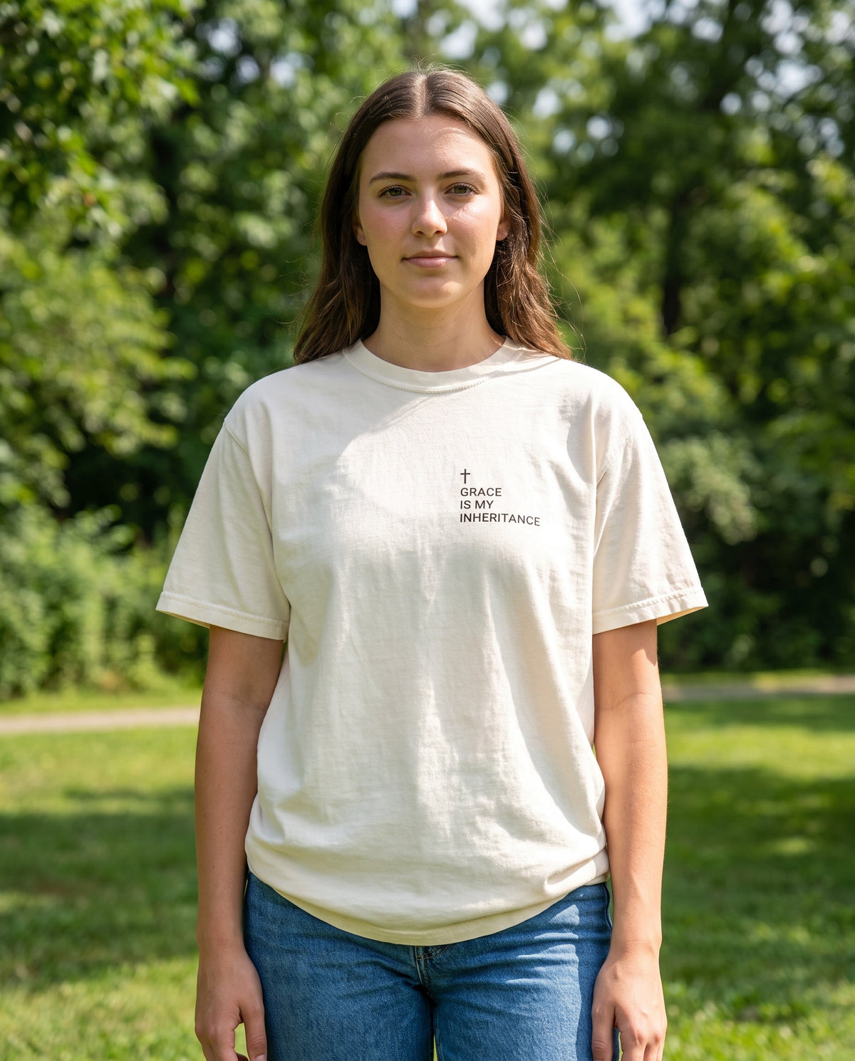 Woman wearing an ivory Grace Is My Inheritance Cross Edition Christian t-shirt, cross chest print