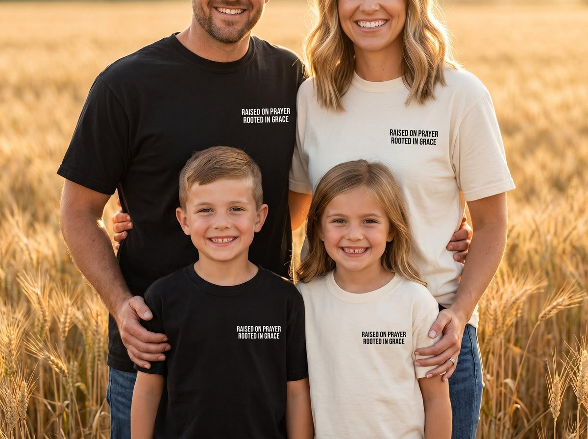 Family wearing matching Raised on Prayer. Rooted in Grace Christian t-shirts