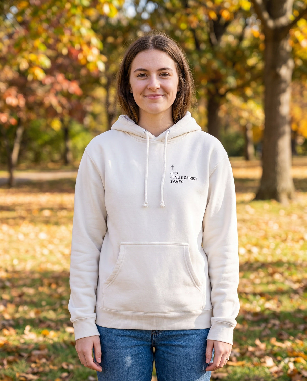 Woman wearing a bone JCS — Jesus Christ Saves Cross Edition Christian hoodie with cross chest print