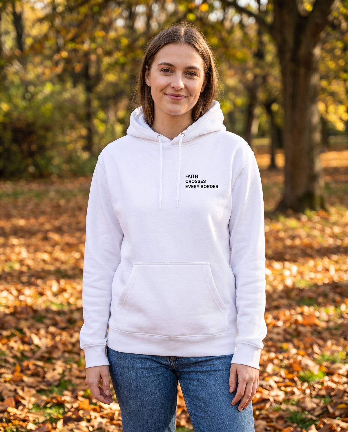 Woman wearing a white Faith Crosses Every Border Christian hoodie, chest print