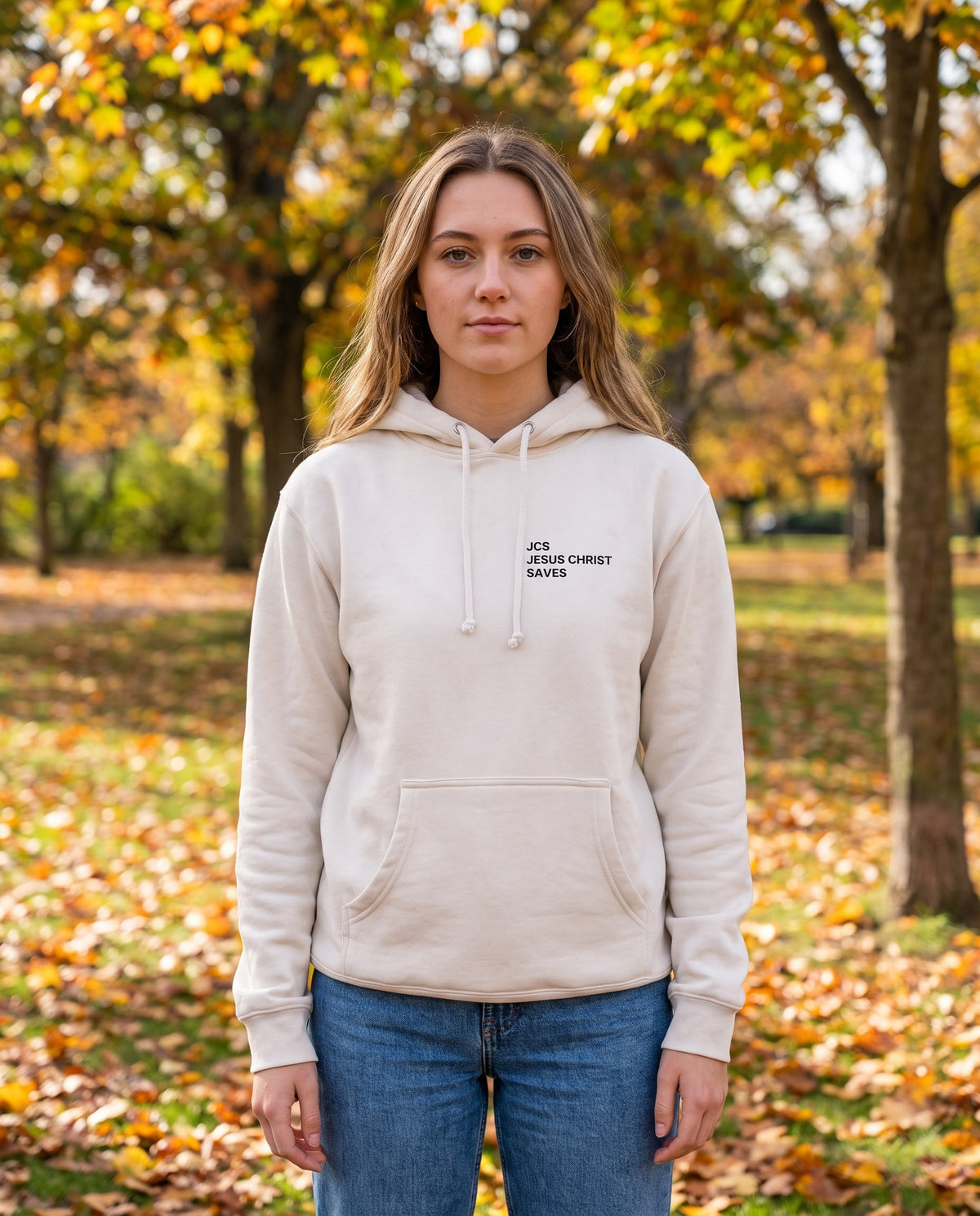 Woman wearing a bone JCS — Jesus Christ Saves Christian hoodie, chest print
